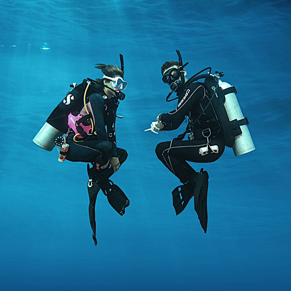 New diver calmly hovering underwater during training