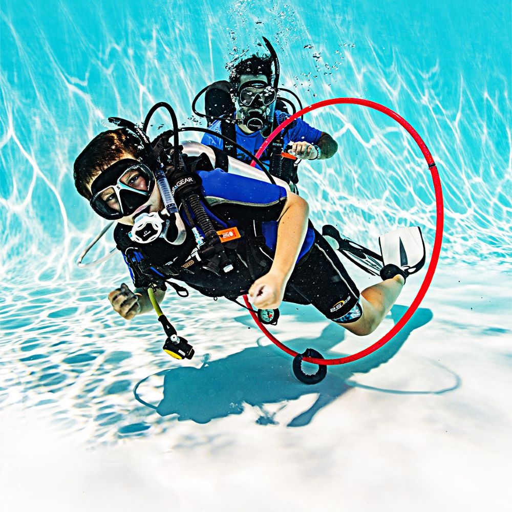 Instructor making a small correction during pool practice